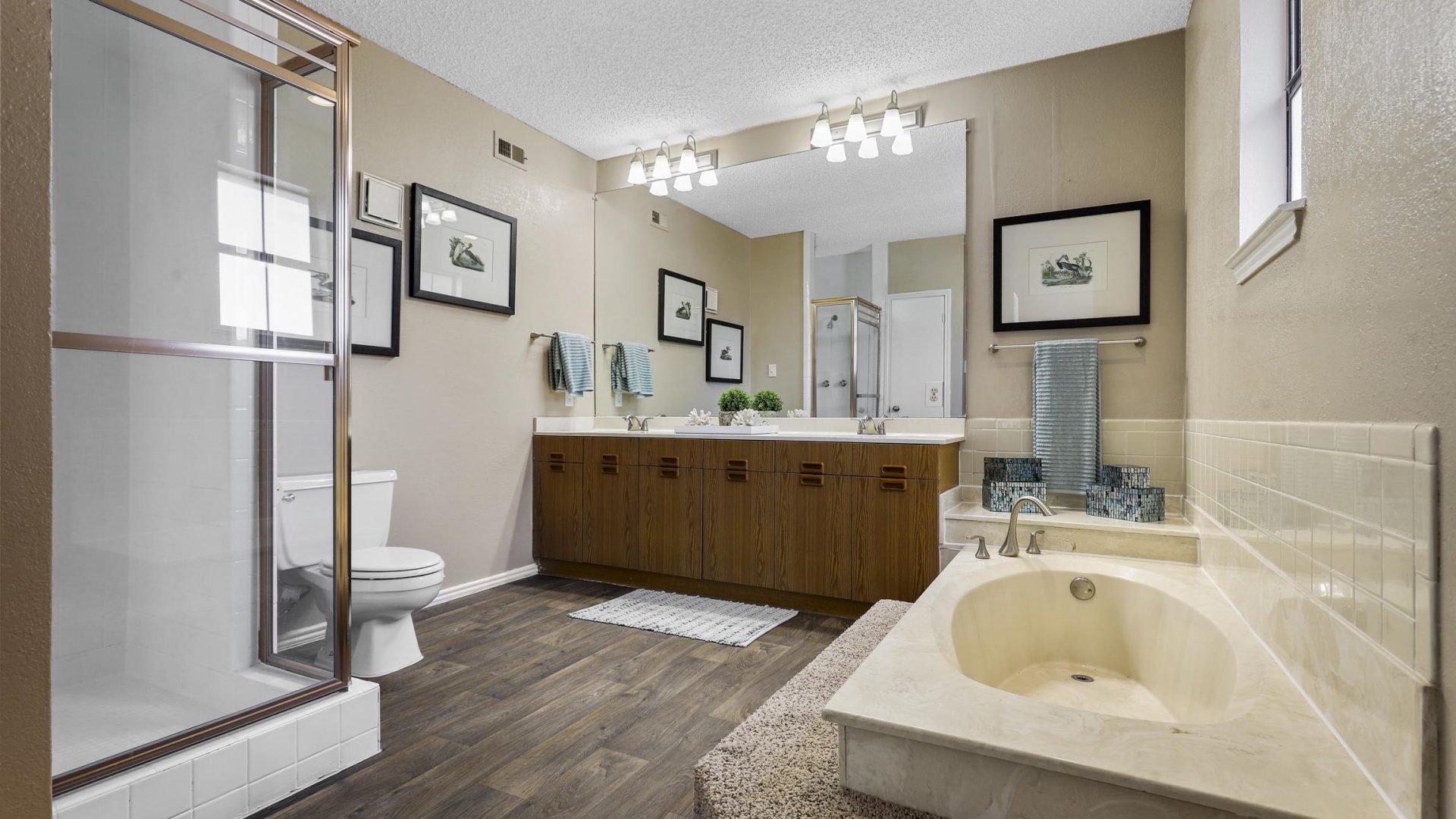 a bathroom with a tub and a shower at The Waterchase Gardens